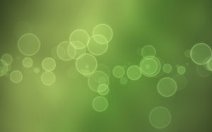 一個美麗的熒光斑點光圈的iOS朦朧的綠色HD幻燈片背景