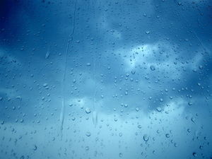Glass on the water droplets blue sky and white clouds synthesis background picture